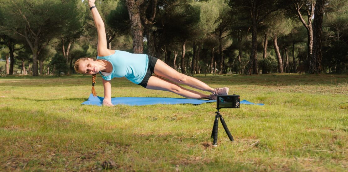 Behind-the-scenes content creator making a video for her fitness students.