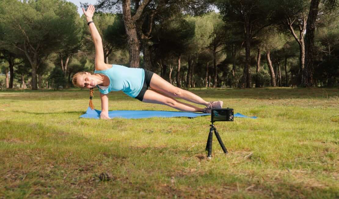Behind-the-scenes content creator making a video for her fitness students.