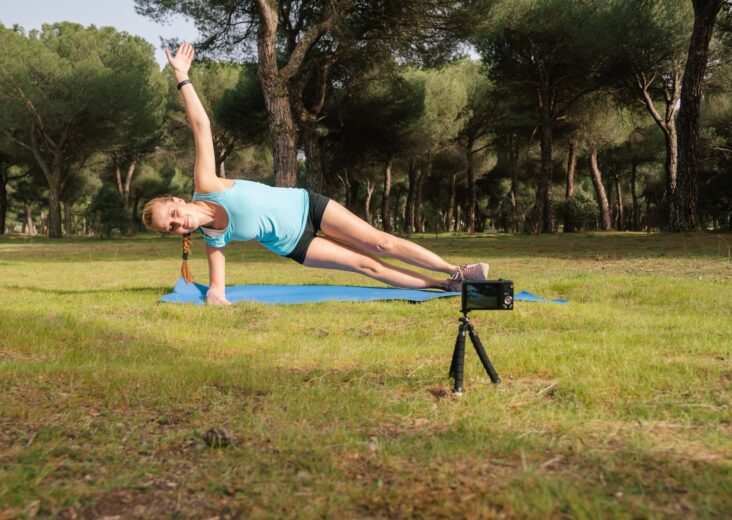 Behind-the-scenes content creator making a video for her fitness students.