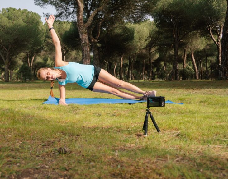 Behind-the-scenes content creator making a video for her fitness students.