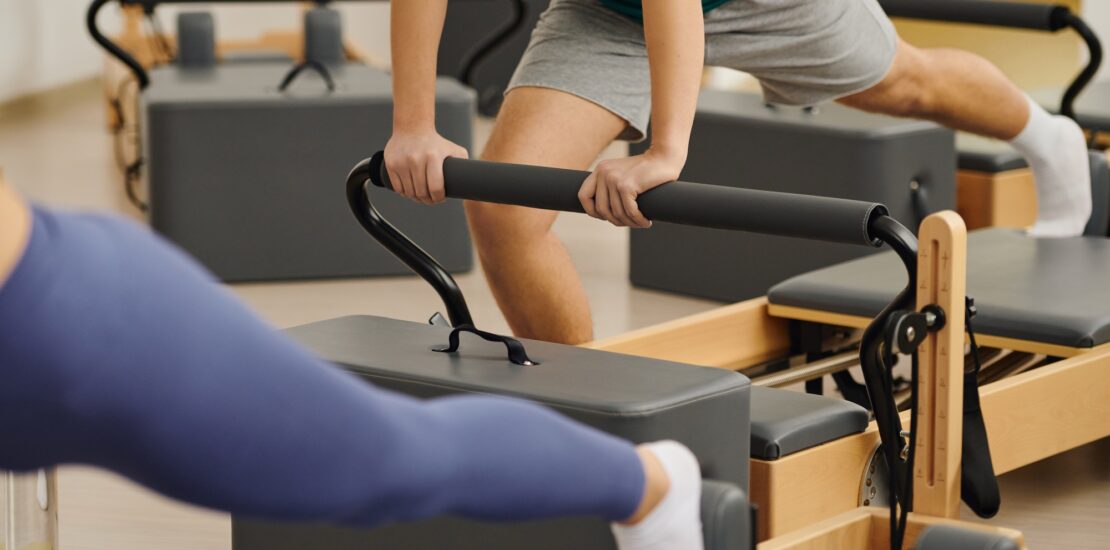 Engaging in dynamic pilates exercises at a modern studio for enhanced fitness and flexibility