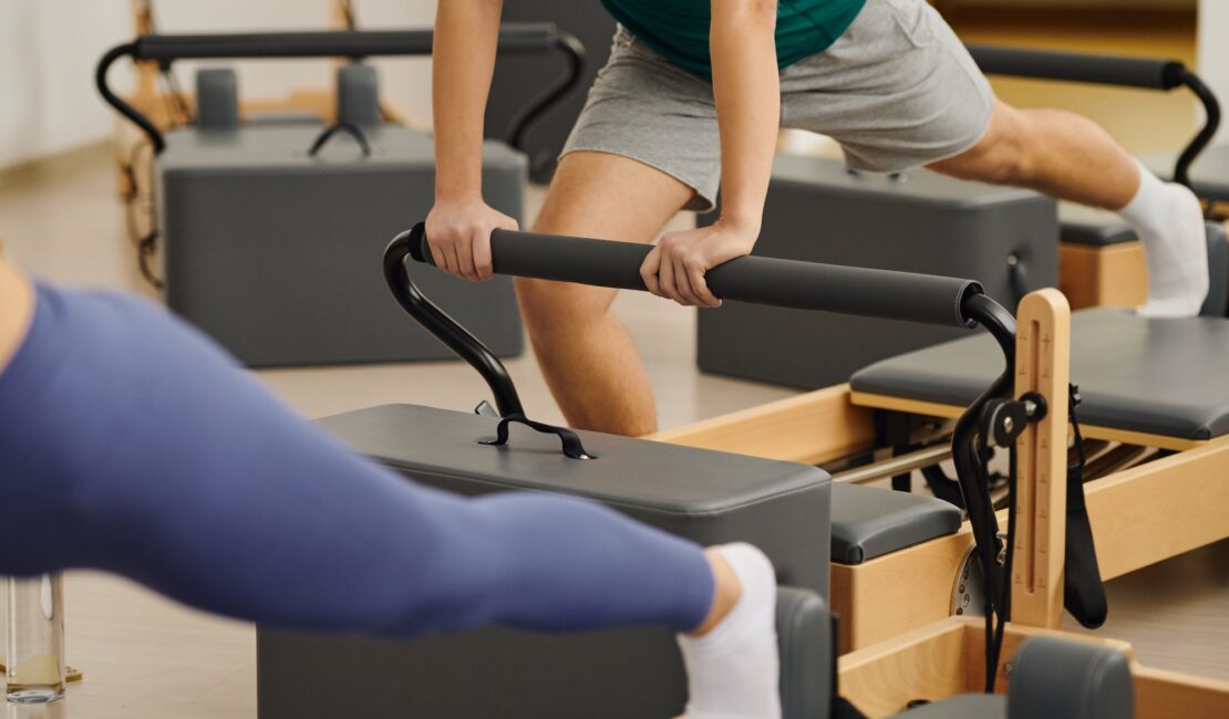 Engaging in dynamic pilates exercises at a modern studio for enhanced fitness and flexibility