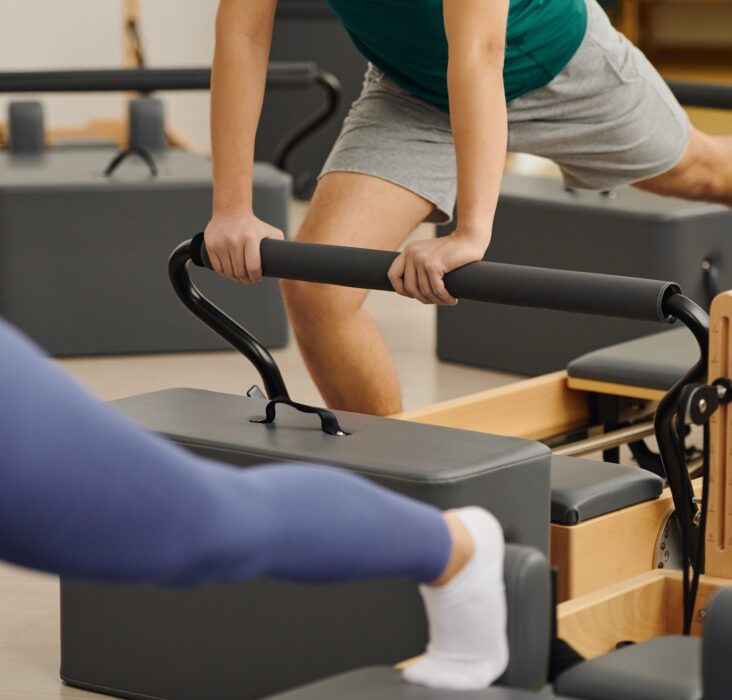 Engaging in dynamic pilates exercises at a modern studio for enhanced fitness and flexibility
