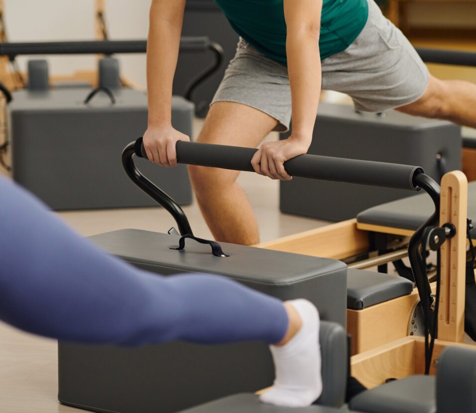 Engaging in dynamic pilates exercises at a modern studio for enhanced fitness and flexibility