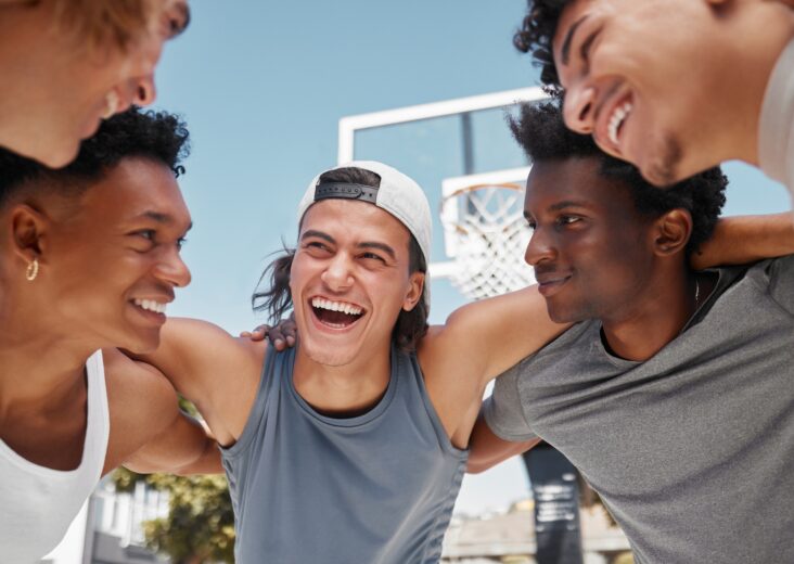 Happy, motivation and team building on a basketball court for a fitness mindset, teamwork and plann