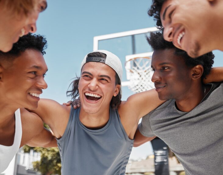 Happy, motivation and team building on a basketball court for a fitness mindset, teamwork and plann