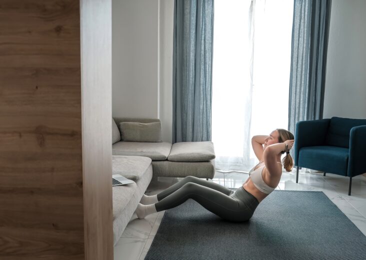 home workout, mindfulness, wellness.Young woman practicing home workout dumbbells during fitness