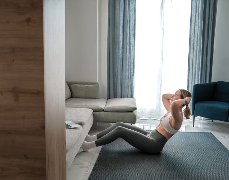 home workout, mindfulness, wellness.Young woman practicing home workout dumbbells during fitness