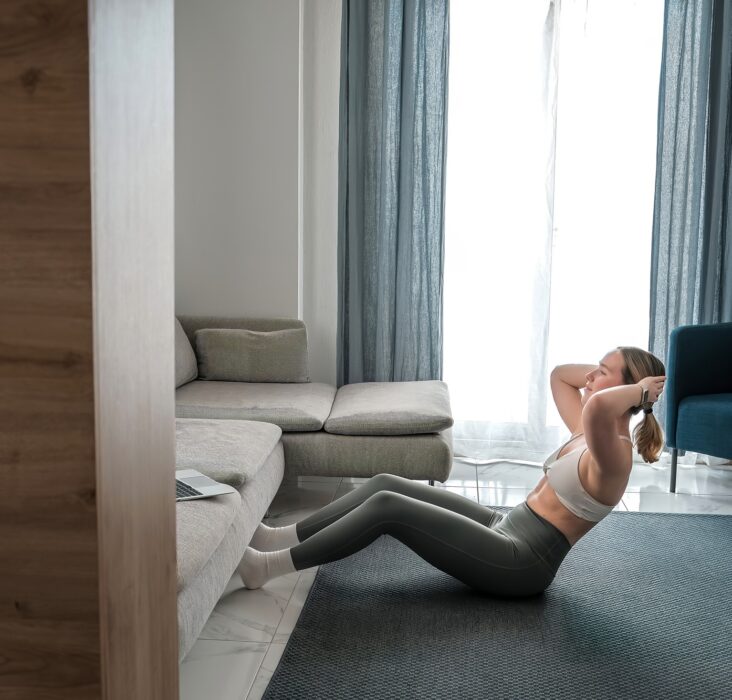 home workout, mindfulness, wellness.Young woman practicing home workout dumbbells during fitness