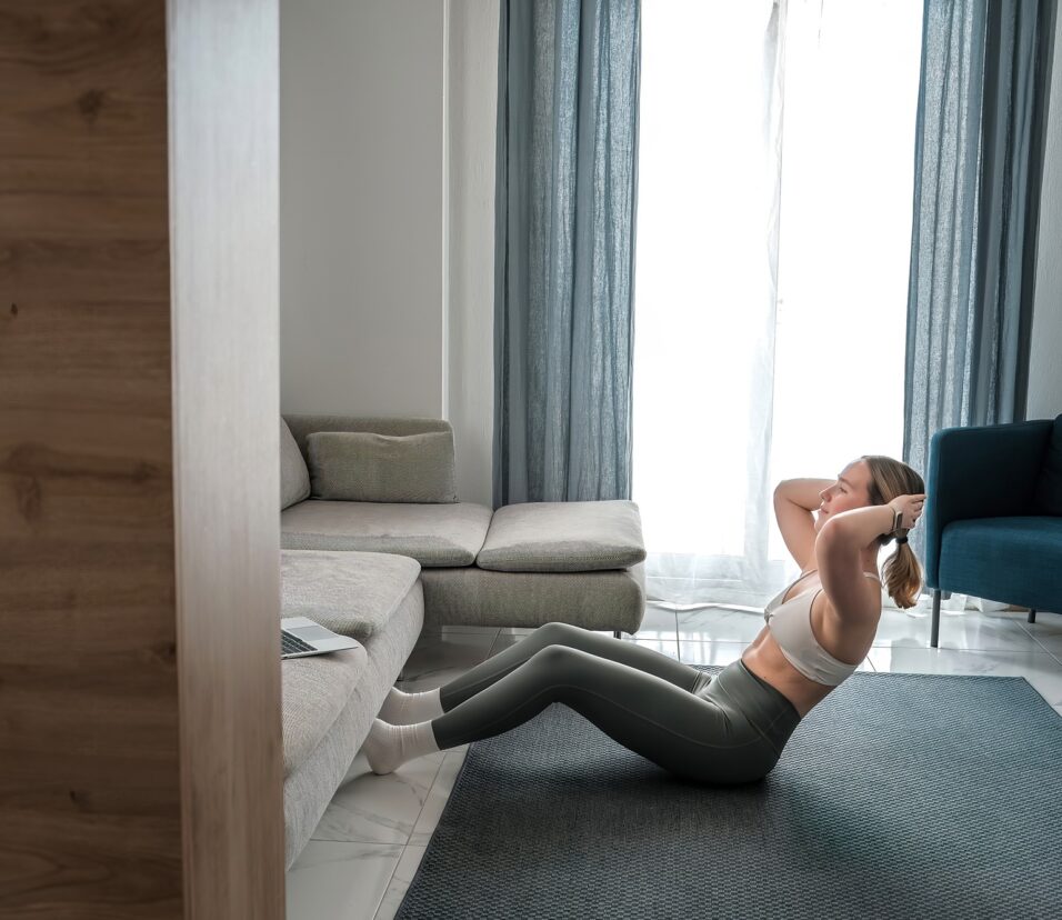 home workout, mindfulness, wellness.Young woman practicing home workout dumbbells during fitness
