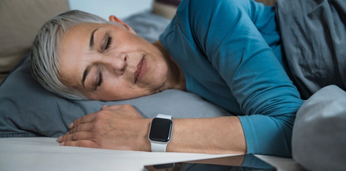 Sleep Apps - Tech-savvy Senior Woman Sleeping in Bed