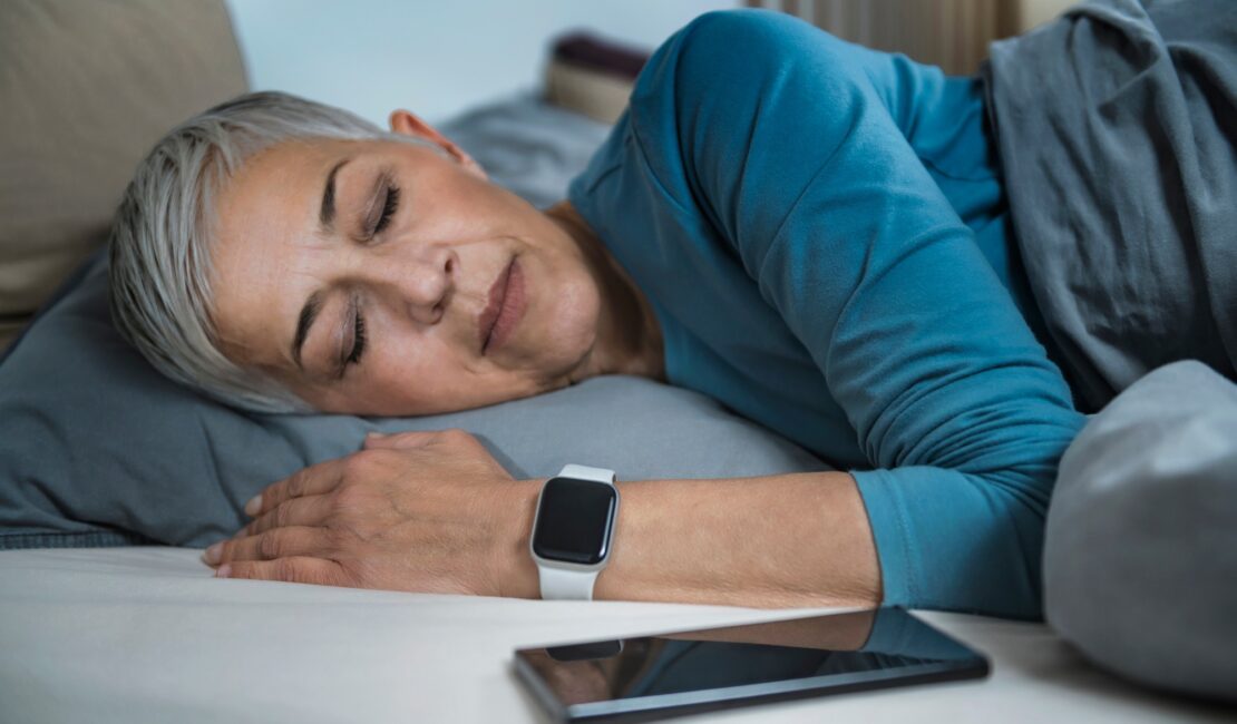 Sleep Apps - Tech-savvy Senior Woman Sleeping in Bed
