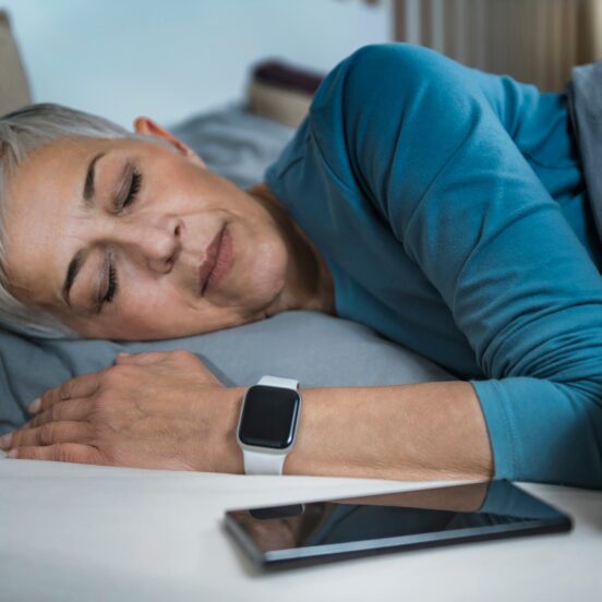 Sleep Apps - Tech-savvy Senior Woman Sleeping in Bed