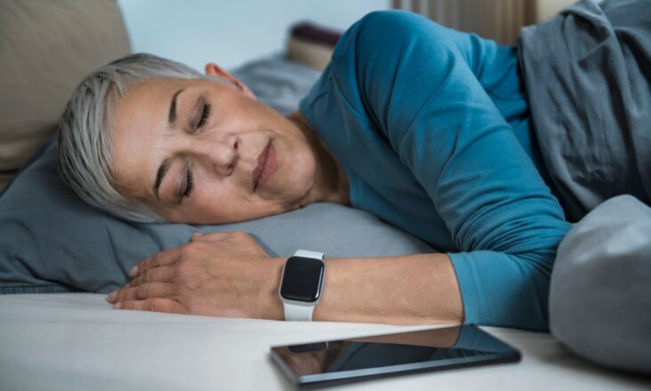 Sleep Apps - Tech-savvy Senior Woman Sleeping in Bed