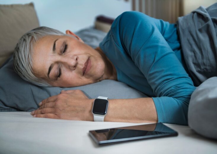 Sleep Apps - Tech-savvy Senior Woman Sleeping in Bed