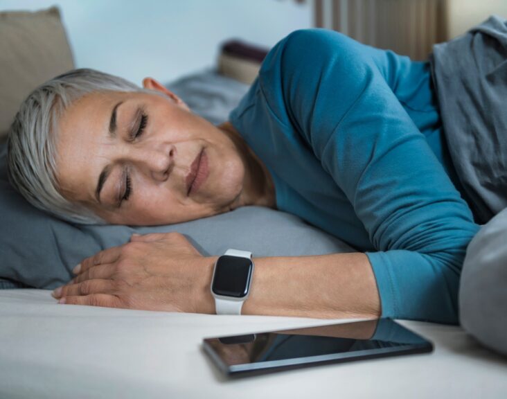 Sleep Apps - Tech-savvy Senior Woman Sleeping in Bed