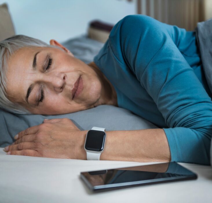 Sleep Apps - Tech-savvy Senior Woman Sleeping in Bed