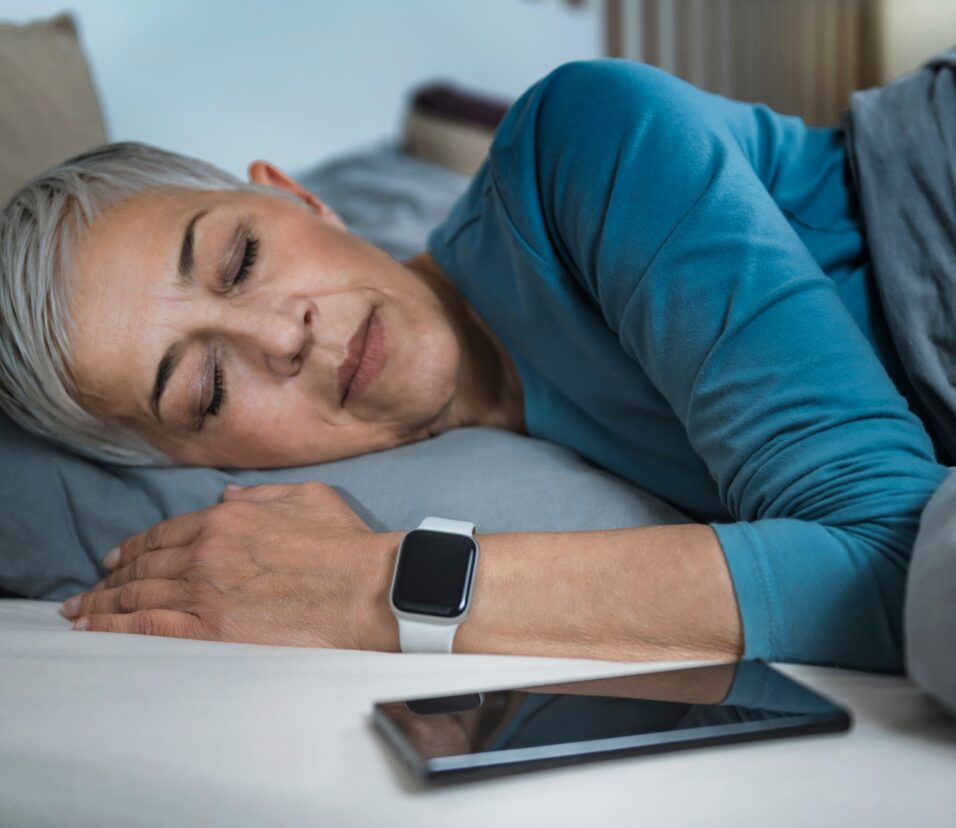 Sleep Apps - Tech-savvy Senior Woman Sleeping in Bed