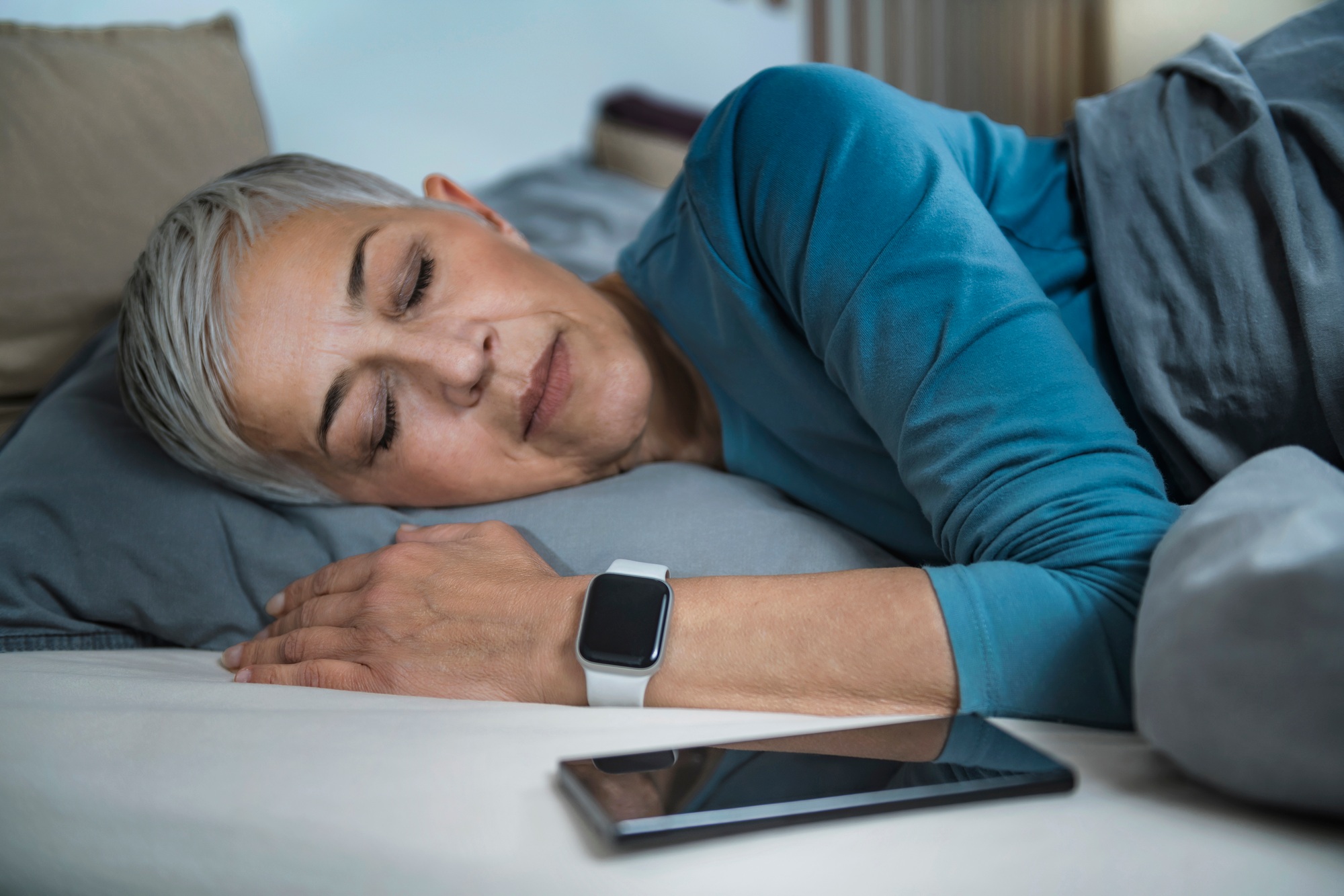 Sleep Apps - Tech-savvy Senior Woman Sleeping in Bed