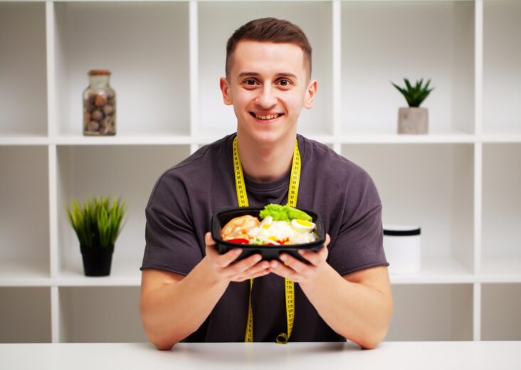 Trainer consumes a high-protein meal of meat and fruits.