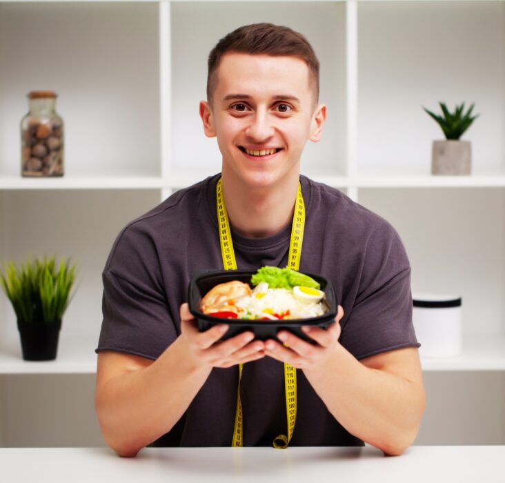 Trainer consumes a high-protein meal of meat and fruits.