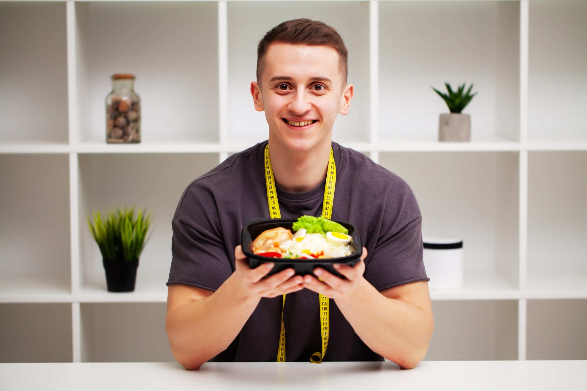 Trainer consumes a high-protein meal of meat and fruits.
